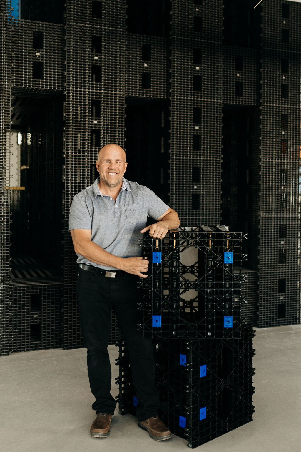 Mike Patey standing in front of a matrix, leaning on an individual piece.