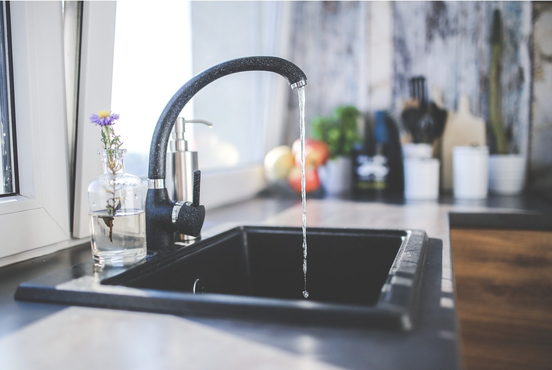 An image of a sink with water running.