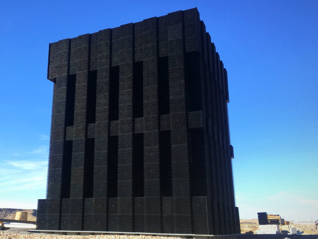 view of the evaporative matrix tower against a blue sky